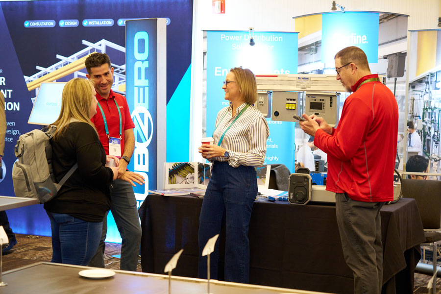 Executive walkthrough of exhibit hall during corporate trade show