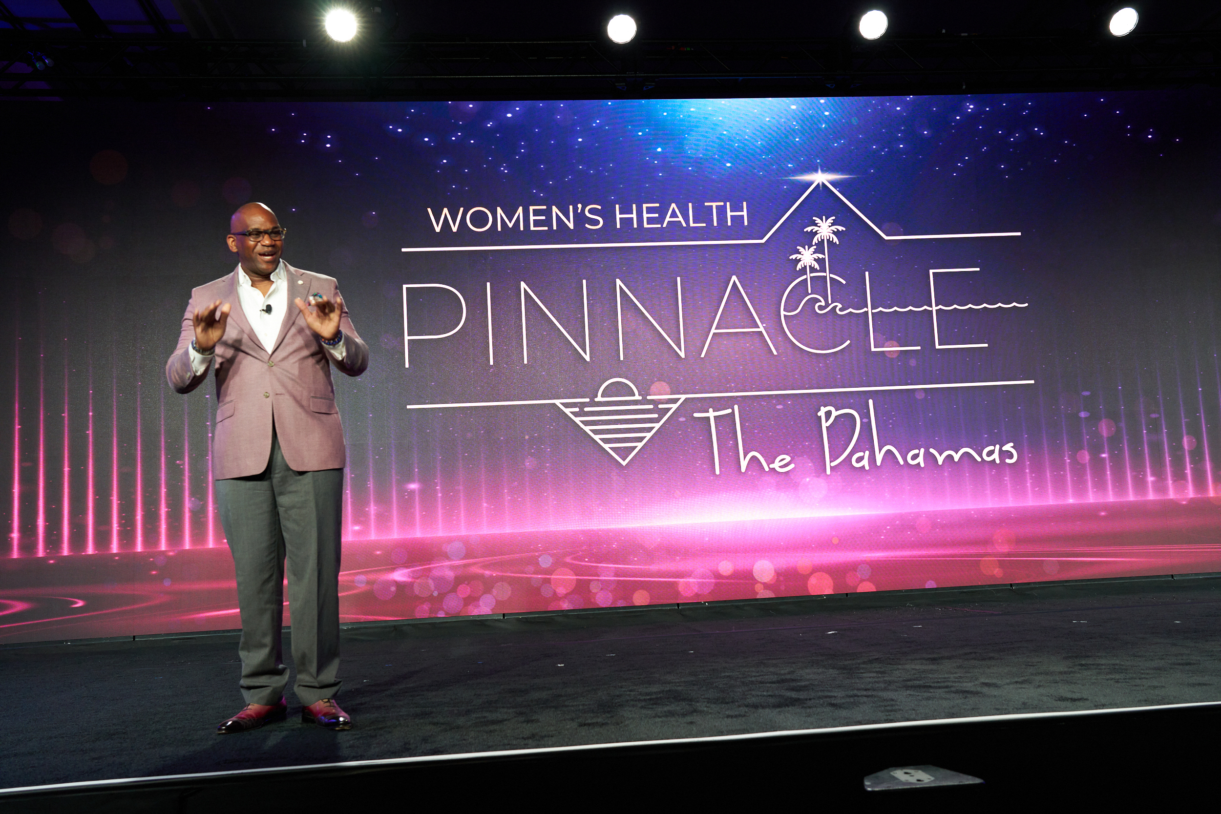 Executive leader speaking during branded corporate incentive travel recognition ceremony