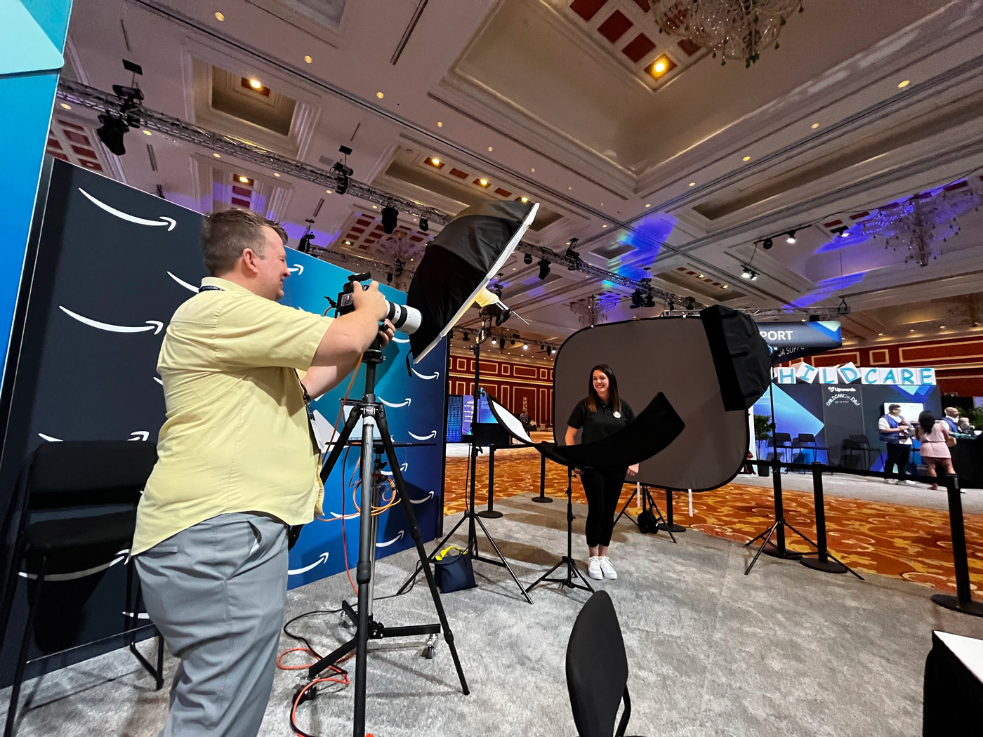Professional photographer creating an attendee headshot at a trade show