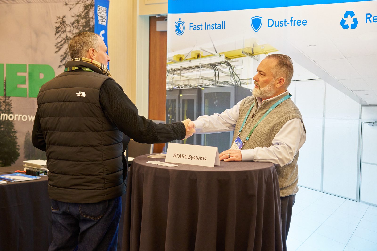 Handshake between an attendee and an exhibitor in the exhibit hall
