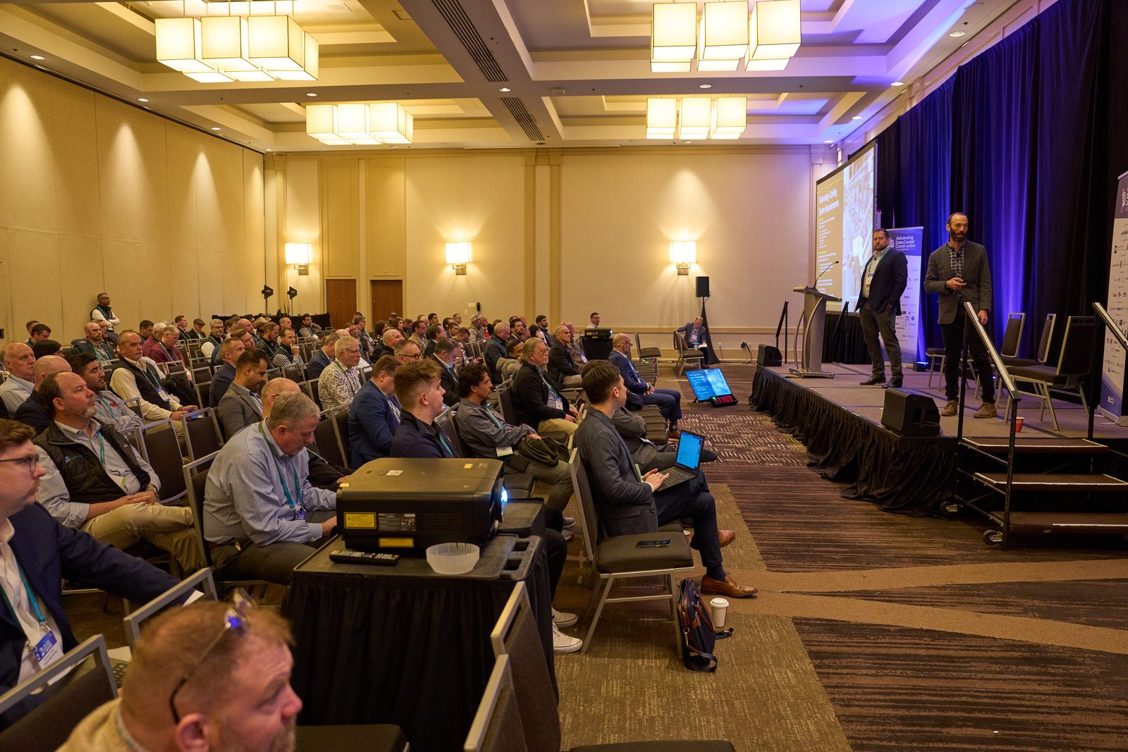 Speakers presenting to a full session room at Advancing Data Center Construction West